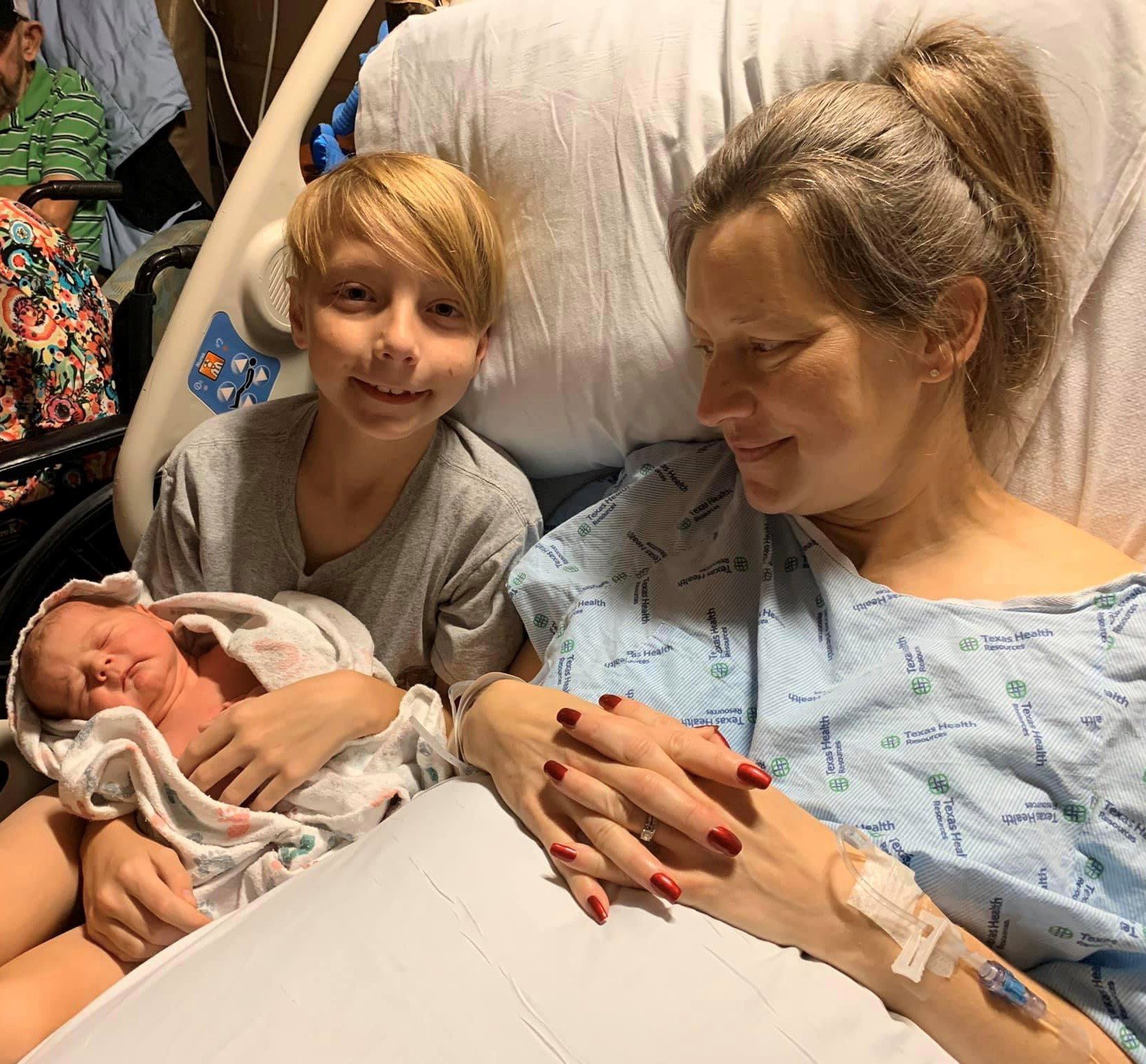 Mother with newborn baby and older son